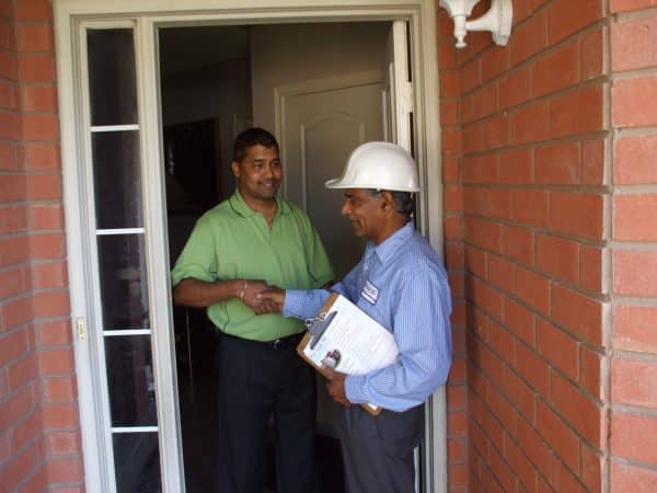 Technicians reviewing the completed work with the homeowner