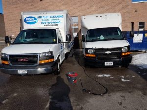 two duct cleaning trucks