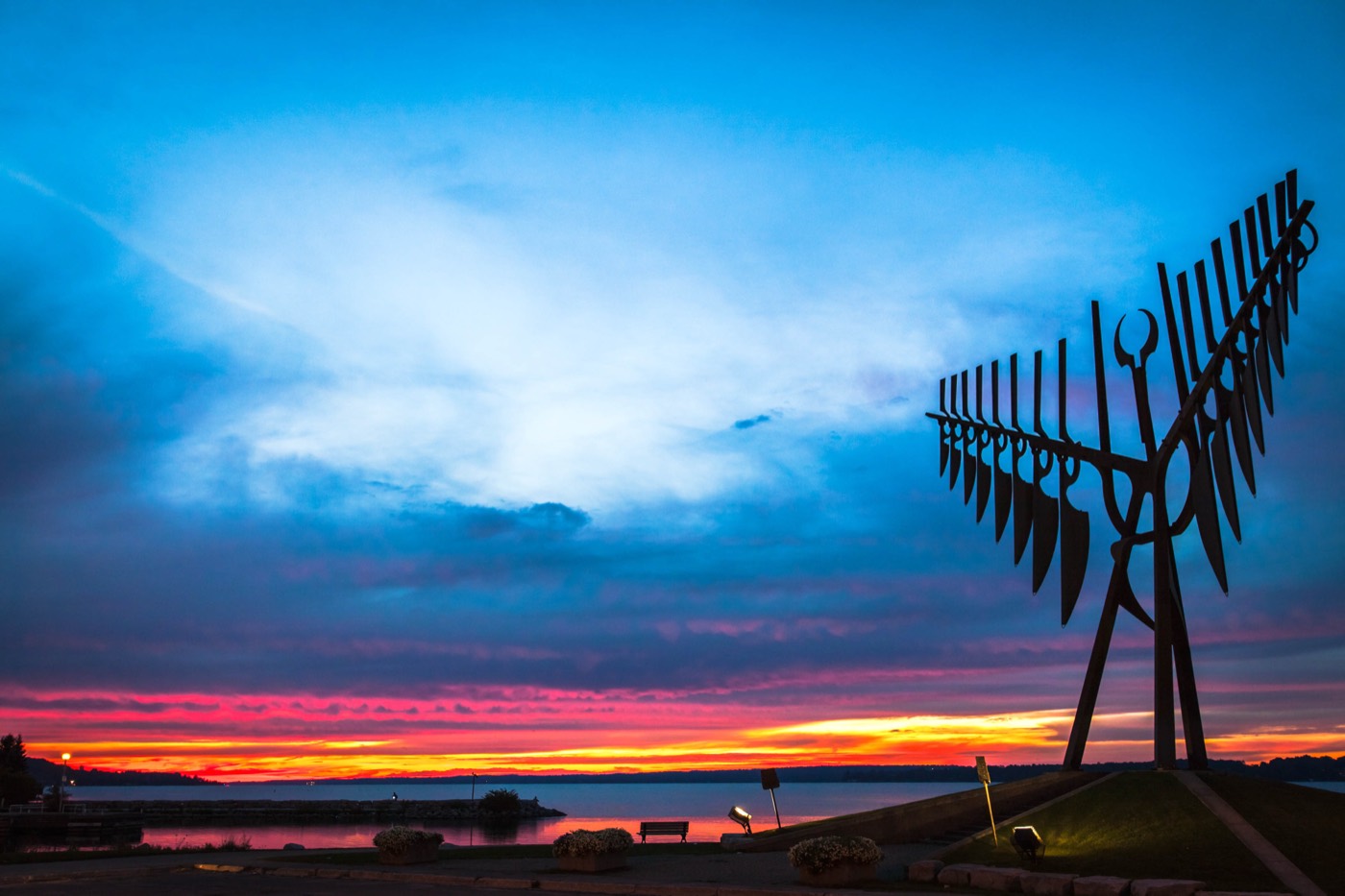 The Spirit Catcher sculpture silhouetted against a sunset sky on the Barrie waterfront overlooking Kempenfelt Bay